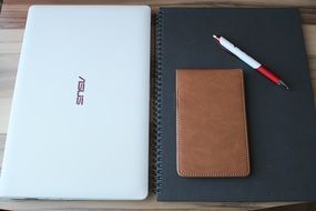 laptop, notebook, pen and mobile phone on the table