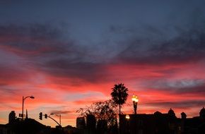 pink sunset above dark city