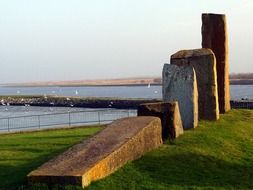 group of scenic big stones on hill in front of sea