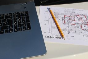 laptop on plan of building