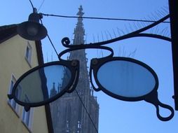 signboard in the form of glasses on the background of Ulm Cathedral