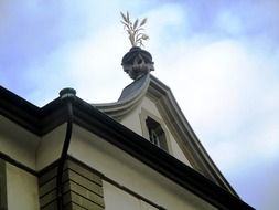 grain symbol on the roof of the grain house at the background of sky