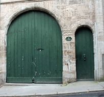 green wooden entrance doors to the building