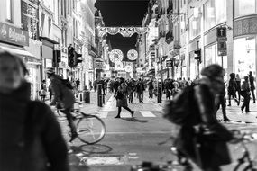 black and white photo of a crowd of people on the road