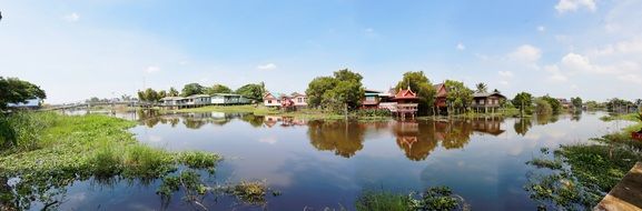 panoramic view of rural houses and river in countryside