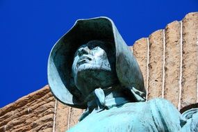 Close-up of the bronze pioneer statue at blue sky