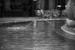 black and white photo spray city fountain