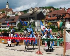 medieval knights with flag on competition in city, germany, neckar