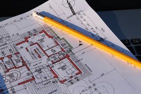 building plan paper pencil laptop