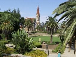 green palm trees in front of a church in Namibia, Africa