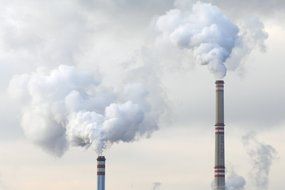 white smoke above chimneys