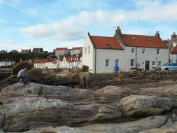 artist painting houses on rocks