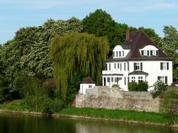 White country house by the river