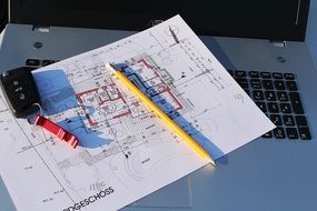 Building project with pencil on laptop