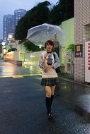 asian Woman with umbrella on street with colorful lights