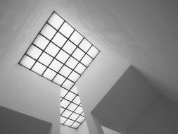 Black and white square window on the ceiling of the museum with bars