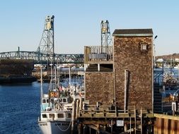 docks in the harbor on the background of the memorial bridge