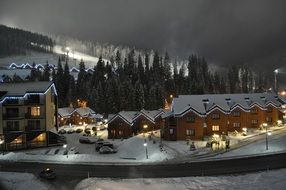 illuminated chalets in the mountains at dusk