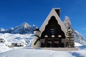 small Christmas cottage covered with snow