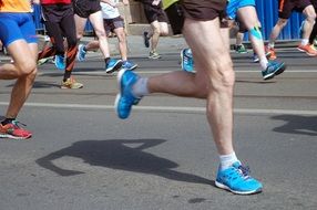 feet of athletes running on the road