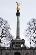 Golden statue of an angel on a column