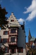 colorful facade of the house with a view of the tower of ulm cathedral