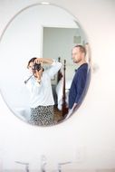 Photographer in a round mirror