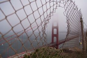 Metal chainlink fence golden gate bridge foggy weather