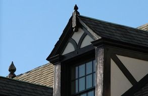 wooden dormer window on gable sloping roof