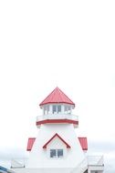 white lighthouse with red roof