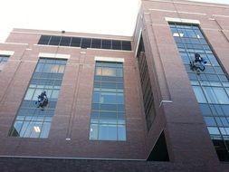 window cleaners on the facade of a modern building