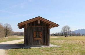 Wooden log cabin in a field