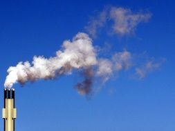 white smoke against the blue sky