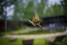 paper bird on the background of nature