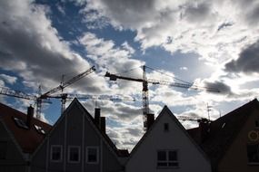 landscape of gable facades and cranes and clouds