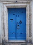 blue wooden door in an old stone building