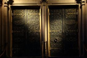 illumination at old ornate metal door