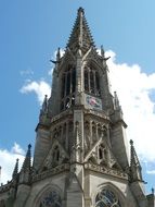 The spire of the church on the sky background