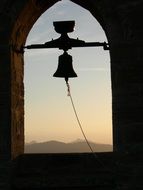 bell in the bell tower at sunset