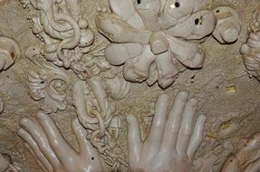 stone carving of hands and flowers