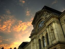 top part of museum of art facade against cloudy sky, switzerland