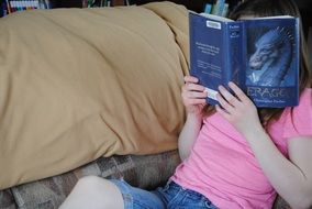 smart young girl reading a book