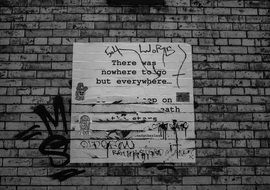 brick wall with poster in Brooklyn, United States