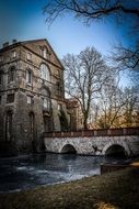 old building at frozen river