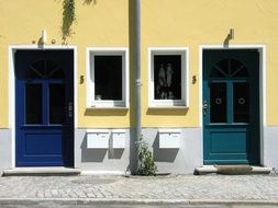 Yellow house with blue doors