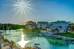 sun shining above beach on florida canal, usa