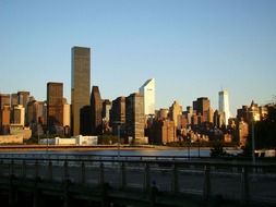 distant view of skyscrapers in manhattan in the sun