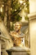 bronze bust in a cemetery in paris