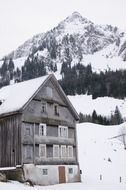 House amongst the snow-capped mountains in switzerland