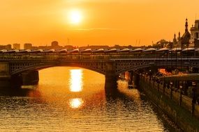 orange sunset over the bridge in london